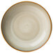 A close up of a Oneida Rustic Sama Porcelain plate with a brown rim and white center.