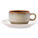 A close up of a white Oneida Rustic Sama porcelain espresso cup and saucer with a handle.