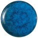 A Oneida Studio Pottery Blue Moss porcelain plate with a blue speckled surface.