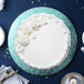 A white cake with frosting on a blue Enjay round cake board.