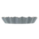 A Matfer Bourgeat fluted metal tartlet mold with a ruffled edge.
