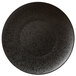 A white porcelain plate with black speckled texture.