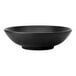 A black Oneida Lava porcelain pedestal bowl with speckled texture.