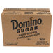 A close up of a Domino Dark Brown Sugar box with black and white text.
