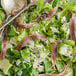 A salad with anchovies and parmesan cheese.