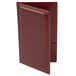 A burgundy leather Menu Solutions guest check presenter with stitching.