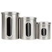 A Fox Run stainless steel ingredient canister set on a kitchen counter. Three stainless steel canisters with lids.