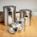 A Fox Run stainless steel 3-piece ingredient canister set on a kitchen counter.
