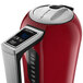 A close-up of a red KitchenAid electric kettle with a digital display.