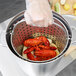 A Vollrath Wear-Ever fryer pot with lobsters and lemons in it.