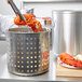 A chef using Vollrath Wear-Ever fryer to cook a lobster.