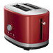 A red and silver KitchenAid 2 slice toaster with a black handle.