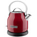 A red KitchenAid electric kettle with a silver handle.