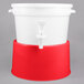 A white beverage dispenser with a red base and lid.