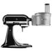 A KitchenAid food processor attachment with black and silver parts.