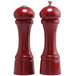Two red Chef Specialties pepper mills with a silver top and black handle.