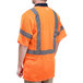 A person wearing a Cordova orange safety vest with reflective stripes.