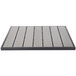 A grey square BFM Seating table top with a black stripe and slats in a patio setting.