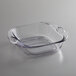 A clear glass square pan with handles.
