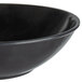 A close-up of a black Vollrath melamine bowl.