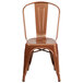 A Flash Furniture copper metal chair with a vertical slat back and drain hole seat.