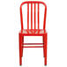 A red metal chair with a vertical slat back.