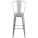 A silver galvanized steel bar stool with a vertical slat back.
