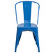A blue metal Flash Furniture chair with a vertical slat back and drain hole seat.