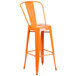 An orange Flash Furniture bar stool with a backrest and seat with a drain hole.