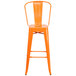 An orange Flash Furniture bar stool with a backrest and seat with a drain hole.