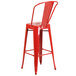 A Flash Furniture red galvanized steel bar stool with backrest.