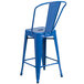 A blue metal counter height stool with a vertical slat back.