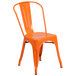An orange Flash Furniture outdoor restaurant chair with a slat back and drain hole seat.