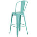 A green mint galvanized steel bar stool with a backrest and drain hole.