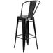 A Flash Furniture black galvanized steel bar stool with a backrest.