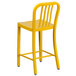 A Flash Furniture yellow metal outdoor counter height stool with a vertical slat back.