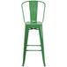 A Flash Furniture green galvanized metal bar stool with backrest.