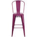 A Flash Furniture purple galvanized steel bar stool with backrest and drain hole seat.