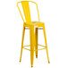 A yellow Flash Furniture galvanized steel bar stool with a slatted seat.