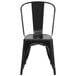 A Flash Furniture black metal chair with a vertical slat back.