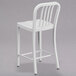 A white Flash Furniture metal counter height stool with a vertical slat back.