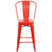 A red metal Flash Furniture counter height stool with a backrest and vertical slat design.