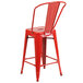 A red Flash Furniture galvanized steel counter height stool with a backrest and seat with a drain hole.