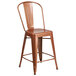 A brown metal Flash Furniture counter height stool with a copper seat and backrest with a drain hole.