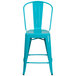 A teal blue galvanized steel counter height stool with a vertical slat back.
