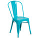 A teal blue metal chair with a vertical slat back and drain hole seat.