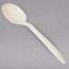 A white cornstarch spoon with a handle.