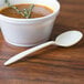 A bowl of soup with a cornstarch soup spoon.