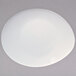 A warm white porcelain oval platter with a circular rim.