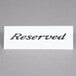 An American Metalcraft white plastic table tent sign with the word "Reserved" on it.